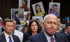 Family members of victims of Boeing Max 8 crashes hold up photographs of their loved ones