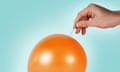 A hand holding a needle presses its tip into a full, orange balloon on a teal background.