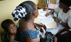 Patient with baby and doctor at clinic in Nigeria.