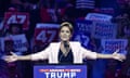 Lake standing at a lectern at a Trump campaign rally in Glendale, Arizona, last week. The lectern reads 'Text Arizona to 88022: Trump'