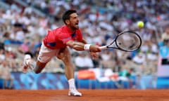 Novak Djokovic plays a forehand against Lorenzo Musetti