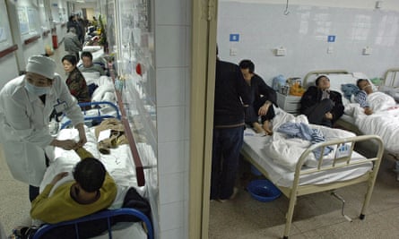 Patients on beds overflowing into the corridors of a hospital in central China’s Anhui province