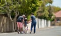 Parents help their little girl learn to ride a bike