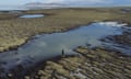 A bird's-eye view of a person standing beside a lake