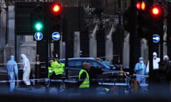 Police examine the vehicle that crashed into the railings of the Houses of Parliament.