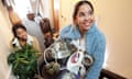 two women moving in to apartment carrying box of possessions and household objects upstairs