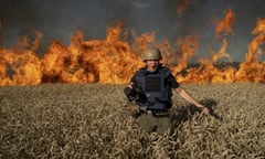 A photograph by Mstyslav Chernov of fellow photojournalist Evgeniy Maloletka as he runs from a burning field after Russian shelling near Kharkiv, Ukraine in July 2022.