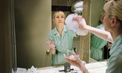 Cleaner polishing the mirror in a hotel