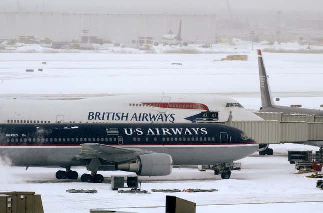 A US Airways and a British Airways plane sit on the tarmac at Philadelphia International Airport February 17, 2003 in Philadelphia, Pennsylvania. All flights into and out of the airport were cancelled due to the severe winter storm 