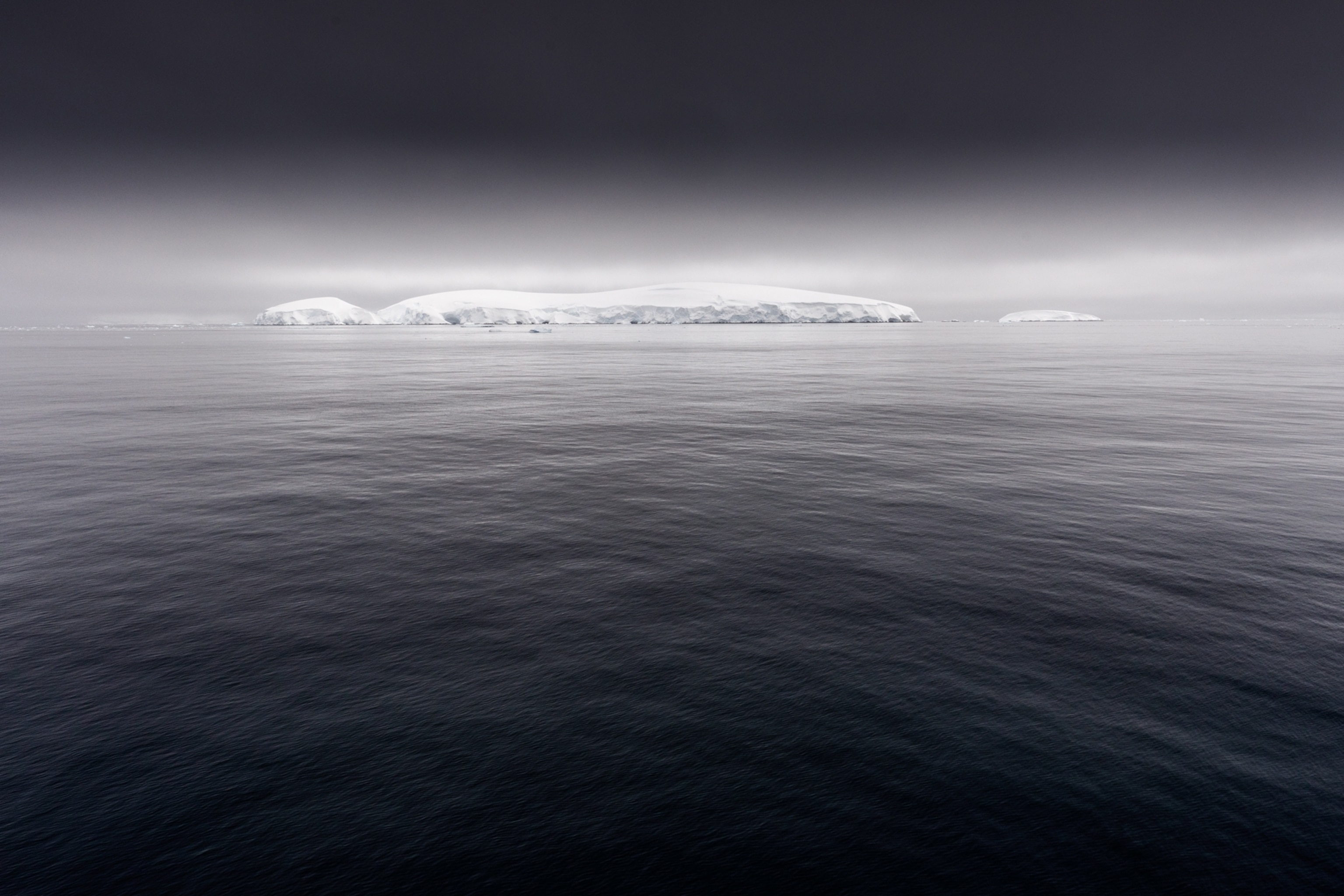 clouds and dark water around ice covered islands in the Gerlache Strait