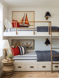 built in bunk beds with sailboat art and red and white and blue striped accent pillows