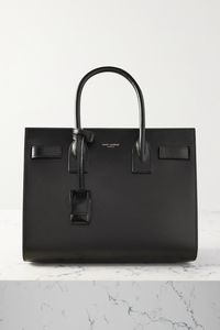 SAINT LAURENT's understated 'Sac De Jour' tote has a structured shape that will fit a book and your makeup bag. Crafted in Italy from black embossed-leather, it has a gold-tone padlock engraved with the brand's moniker and a zipped compartment for your smaller possessions. Use it every day or as a carry-on when travelling.