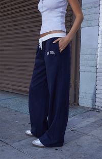 Lounge around in total comfort this season in the new John Galt New York Anastasia Sweatpants. These classic sweatpants feature an adjustable contrast drawstring waistband for the perfect fit, New York embroidery at the hip, side pockets, and a wide relaxed leg.   	Solid color sweatpants 	12" rise 	29" inseam 	Low-rise 	Drawstring waistband 	Side pockets 	New York embroidery 	Wide relaxed legs 	82% cotton, 18% polyester 	Machine washable 	Fits size 23" - 25" waist 	One size fits most 	Model measurements: 5’5” height, 30” bust, 24” waist, 31” hip