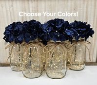 "This six piece set includes your choice of hydrangea color. Choose pint size or quart size...or a set of both. Each centerpiece jar includes one set of warm white LED fairy lights, and one silk hydrangea, and a jute bow.  These centerpieces are very popular for weddings, baby showers, parties, corporate events, holiday events, and any other event that requires table centerpieces. They also look great in any room of your house or office. To see other lighted jar options and all of my other listings, please view my shop: https://www.etsy.com/shop/GlassyGalDecor  Listing pic: Navy Blue hydrangeas in quart size jars are shown in this listing pic, but other color choices are available. Each jar set includes: (1) clear mason jar (1) set of LED fairy lights (1) faux hydrangea stem (1) jute bow D