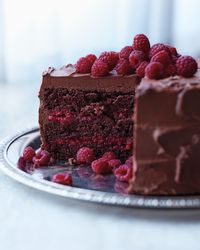 Make this chocolate-raspberry cake recipe for dessert, complete with a rich cream cheese frosting and whole berries scattered on top.