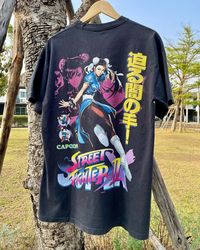 Looking for some awesome vintage CAPCOM game tees featuring Street Fighter's iconic Chun Li? Check out our Pinterest board for some rare finds that are sure to turn heads! From gaming nostalgia to fashion inspiration, these vintage tees are a must-have for any Street Fighter fan. Don't miss out on these rare gems!