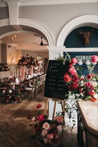 Black seating chart, red and pink flowers