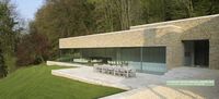 Large, modern extension to Grade II keepers cottage in the Cotswolds. Using a wall of frameless structural glass and thin framed sliding glass doors