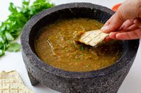 This salsa molcajeteada combines pan roasted tomatoes, garlic, and peppers to make a spicy and hearty salsa. Made in an authentic molcajete.