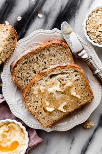 This no-knead honey oat bread recipe is straightforward and simple AND delivers delicious, flavorful results. The bread is chewy, soft, and hearty. Most of the “work” is completely hands off as the dough rises. Easy beginner bread recipe!