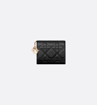 The Lady Dior Lotus wallet is offered in an elegant and compact version. Crafted in black lambskin, it honors House codes with its timeless Cannage topstitching and detachable D.I.O.R. charms. The compact accessory is an ideal companion and may easily be slipped into any bag or clutch..