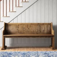 Why not welcome a well-made woodworking touch into your entryway with this solid wood bench? It's crafted from reliable, solid pine wood in a washed finish for a look that fits right in with rustic and farmhouse decor. This vintage-inspired finish still lets plenty of the natural wood grain shine through. This bench is fashioned in clean and straightforward lines, with curved armrests, a paneled seat back, and pedestal legs on top of beveled feet. We think it's just right for sitting down to kic