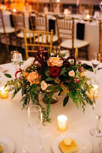 Pine, cedar, roses, and garden floral in gold footed compote bowls for low centerpiece on guest tables.  Flowers by Lowes Greenhouse, Chagrin Falls OH. Photo by Brittany Graham Photography