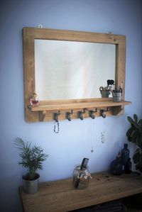 Our custom handmade modern rustic mirror with shelf has a chunky natural, sustainable wooden frame with 5 cast iron hooks; perfect for storing your dressing gown, hairdressing items and make up. Contact Marc and Rachel in Somerset for details enquiries@marcwoodfurniture.co.uk or call 0146053377 #ideas #inspiration #styling #salon #barbershop #mirror #shelf #hooks #iron #wood #sustainable #UK #buy #rustic #cottage #home #ideas #inspiration #decor #UK