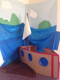 Shipwrecked room. I used tablecloths for the backdrop and for the sail. I made the boat from cardboard.