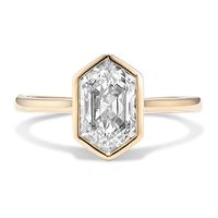 This stylish bezel-set engagement ring features a sparkling 1 1/2 ct. lab-grown diamond in a unique elongated hexagon cut. Crafted in warm 14-karat yellow gold  it has extra lab-grown diamond accents on the sides  so it sparkles from every angle.