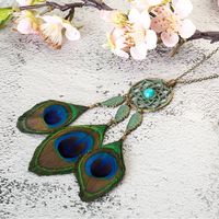 The most beautiful feather on a beautiful necklace! Peacock feathers are among the most stunning in the world! This dream-catcher-style necklace with metal and real peacock feathers and a lovely detailed bead design is gorgeous!