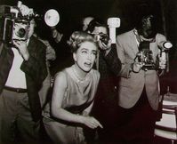 Joan Crawford surrounded by the paparazzi