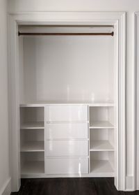 Small-custom-closet-with-wooden-hanging-rod