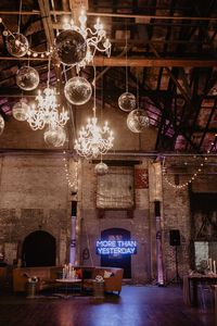 For the reception at the main hall, string lights, crystal chandeliers, and disco balls hung above the dance floor, while a lounge, complete with a neon sign, served as the focal point. l Image by Nicole Nero