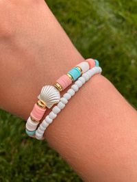 Trendy preppy bracelet 🐚 *Handmade Bracelet set - comes with 2 bracelets (one white seed bead and one blue, coral, white clay bead with shell) *Bracelet length is 6 1/2 inches long with stretchy string *Tie closure Great for stacking or wear alone.  Create your own unique stack with other bracelets from my shop! Willow approved 🐰!