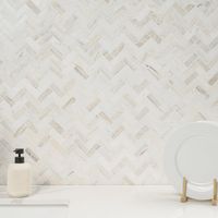 With Angora Marble Mosaic Tile, add a splash of contemporary styling to your decor. This attractive tile features chips of natural marble tile in a herringbone pattern on a mesh sheet that makes installation a much easier process. With neutral beige shades of authentic marble in a polished finish, this tile creates a distinct pattern for installations in kitchens, bathrooms, and other residential or commercial spaces. Note: Natural stone products are subject to variation in color, shade, finish,