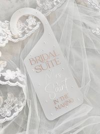 Bridal Door Hanger, Gift for Bride, Do not Disturb, Bride Getting Ready Hanger, Bride in Progress, Wedding Hotel Do Not Disturb, Wedding Day My Bride to be door hangers are every Brides Wedding morning must have! My Bridal Suite door hanger is personalised and made using premium gloss acrylic, with added pearl detail, with the surname of choice! These really do make the perfect gift for any Bride to be for their Wedding morning!  Dimensions: 19.5cm x 7cm aprox  My Do not disturb the bride door hangers are handmade to order and dispatched within 10 business days.  My Bride to be door hanger will be sent via Royal Mail 2nd Class.  If you require your Bride to be door hanger sooner, please just pop me a message and I will do my best to help.