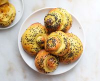 Sourdough challah snails are made using sourdough starter, eggs, and honey. They're rolled up to symbolize the new year.