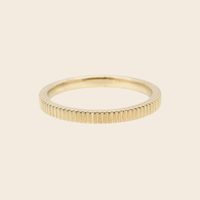 Meet our fluted gold line wedding band. The Juniper Line Band is textured with shimmering vertical grooves. This soft finish plays with light to create the most beautiful twinkle. It reminds us of golden hour, dancing the night away and a good belly laugh all at once! Have your 70's disco moment, but make it timeless with this band! Contact us to book a free consultation.