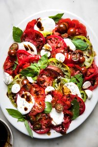 Juicy tomatoes at their summertime peak and milky, tender fresh mozzarella come together in this classic Caprese salad recipe and, friends, it is a beautiful, beautiful thing.