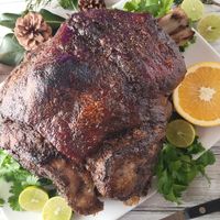 Pernil Asado Puertorriqueño is a mouthwatering holiday classic! This marinated, bone-in pork roast delivers tender, juicy meat and irresistible crispy skin, repeatedly earning its place as the star of any gathering or holiday dinner.