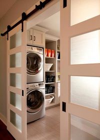 Sliding track doors to laundry room, white and glass doors, wood grain tile | VanBrouck & Associates, Inc. #”laundryroomstorageideas”