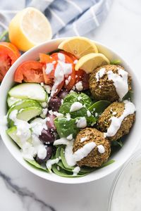 Crispy, easy, delicious Falafel bites made in your Air Fryer or baked in your oven and drizzled with a homemade Tzatziki dressing .  The perfect meatless dinner or lunch option. Air fryer falafel| Gluten-free falafel | Baked falafel | Healthy falafel| Falafel recipe| Easy falafel recipe | 21 Day Fix Falafel Recipe | Vegan Falafel | Zero Point Falafel #confessionsofafitfoodie