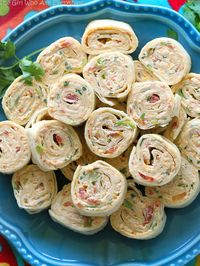 These Chicken Enchilada Roll Ups are a great appetizer for parties! Easy to make ahead and easy to serve. the-girl-who-ate-everything.com