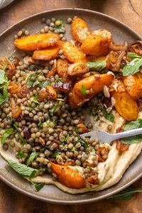 This Roasted Carrot and Lentil Salad is loaded with spiced shallots, hearty French lentils, dates, olives and toasted almonds. Serve everything over hummus with fresh mint and a pinch of flaky sea salt. It’s salty, sweet and savory—perfect for a healthy winter main or side.