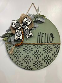 Dress up your front door with this rustic aztec door hanger. Approximate dimensions 16" round, 1/2" thick. Bow may fluctuate depending on in stock ribbon.