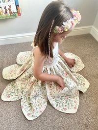 Youtube sew along: https://youtu.be/eVtIN0gJelU Sizes: 12 Month to 10 YearsSkill level: IntermediateFormats: A4/Letter, A0, ProjectorFabric: Woven The dress is an enchanting and whimsical piece. Bodice is fully lined with ties at the back. The back bodice features elastic, providing a snug fit. The sleeveless design and open back is ideal for warm weather or special occasions. The skirt is the highlight of this dress, with its petal-like layers that evoke the enchanting style of Tinker Bell’s dress. Underskirt adds volume and movement. After completing your purchase you will receive 4 PDFs:• Step by step photo tutorial that explains in detail how to construct the garment• Pattern in A4/Letter format that can be printed on A4/Letter paper• Pattern in A0 format that can be printed on A0 pape