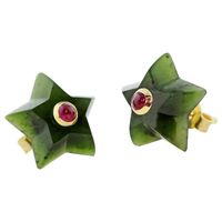 For Sale on 1stDibs - This charming pair of stud earrings is entirely hand carved and made in jade, shaped as stars and adorned in the center with cabochon ruby. The mounting