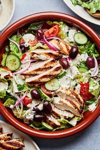 A mix of Greek yogurt, mayo, herbs, evoo and vinegar does double duty as a marinade for grilled chicken and a dressing for a crispy salad of romaine, cucumbers, tomatoes, olives, and red onion.