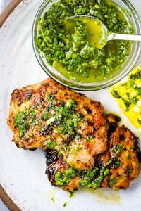 Juicy, tender, grilled boneless skinless chicken thighs are served with a flavor-packed chimichurri sauce that is used as both a marinade and topping. Feel free to use chicken breasts or drumsticks instead. A perfect quick and easy summer meal!